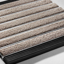Close-up of a carpeted stair tread with a metal stair case.